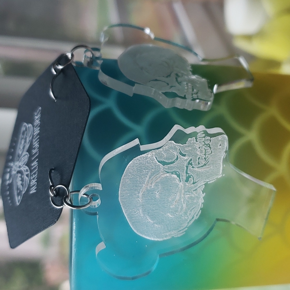 Silhouette profile engraved skull earrings